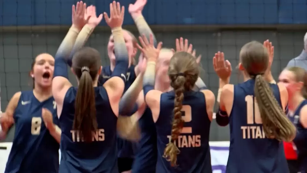 Varsity volleyball celebrates after winning states.