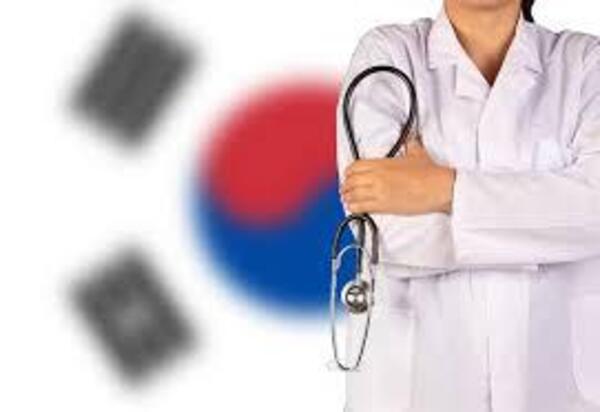 South Koreas flag behind a medical professional in the midst of a medical crisis.