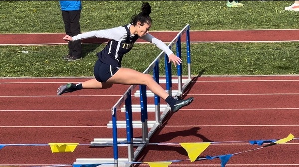 Abby running hurdles.