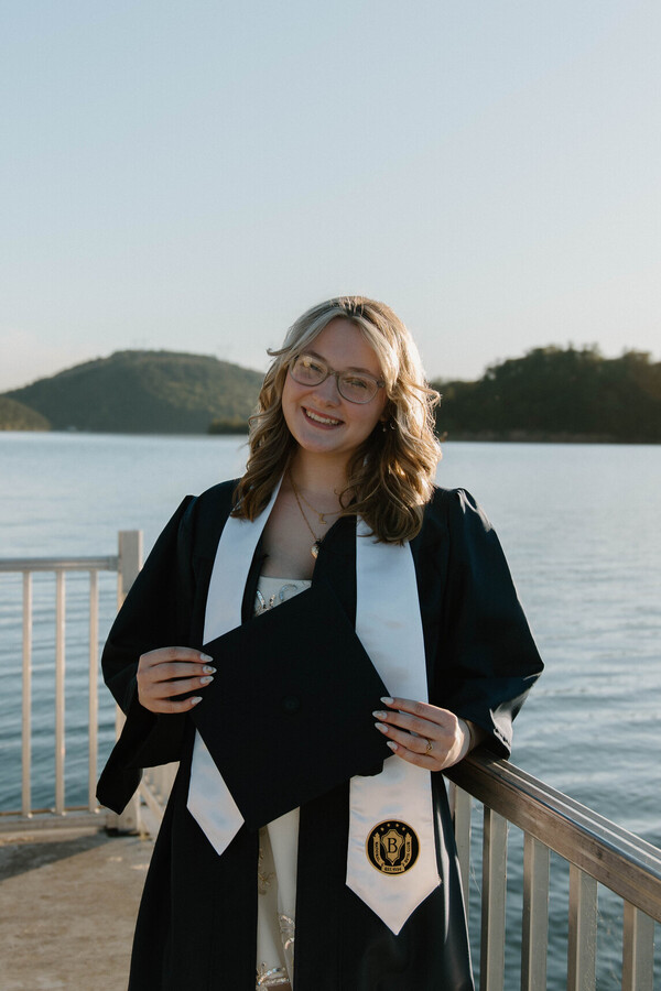 Lilly dressed out in a cap and gown for her senior photos. 