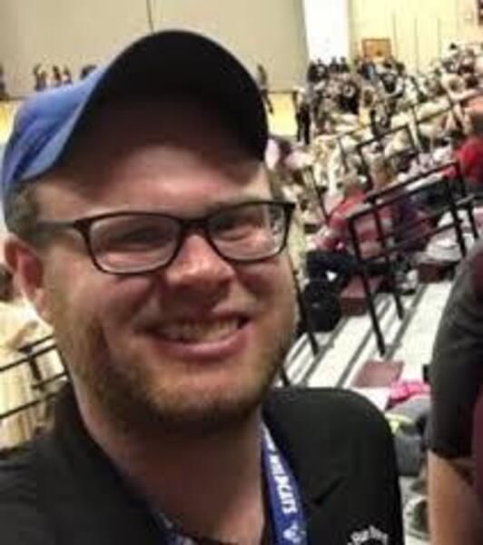Mr. Chisum smiles at student event.