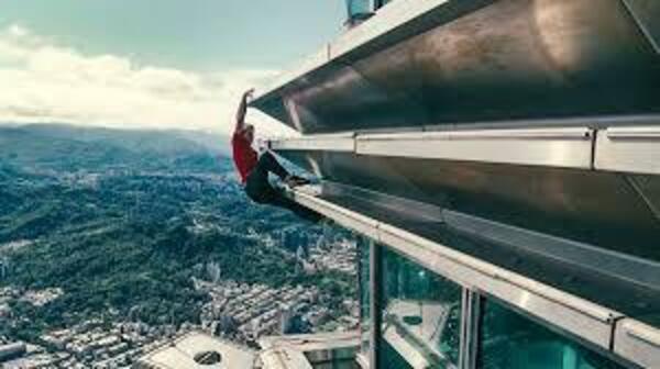 Alex Honnold climbing the base of Taipei 101's spire.
