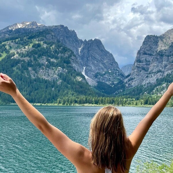 Isabella embracing nature amidst a picturesque setting